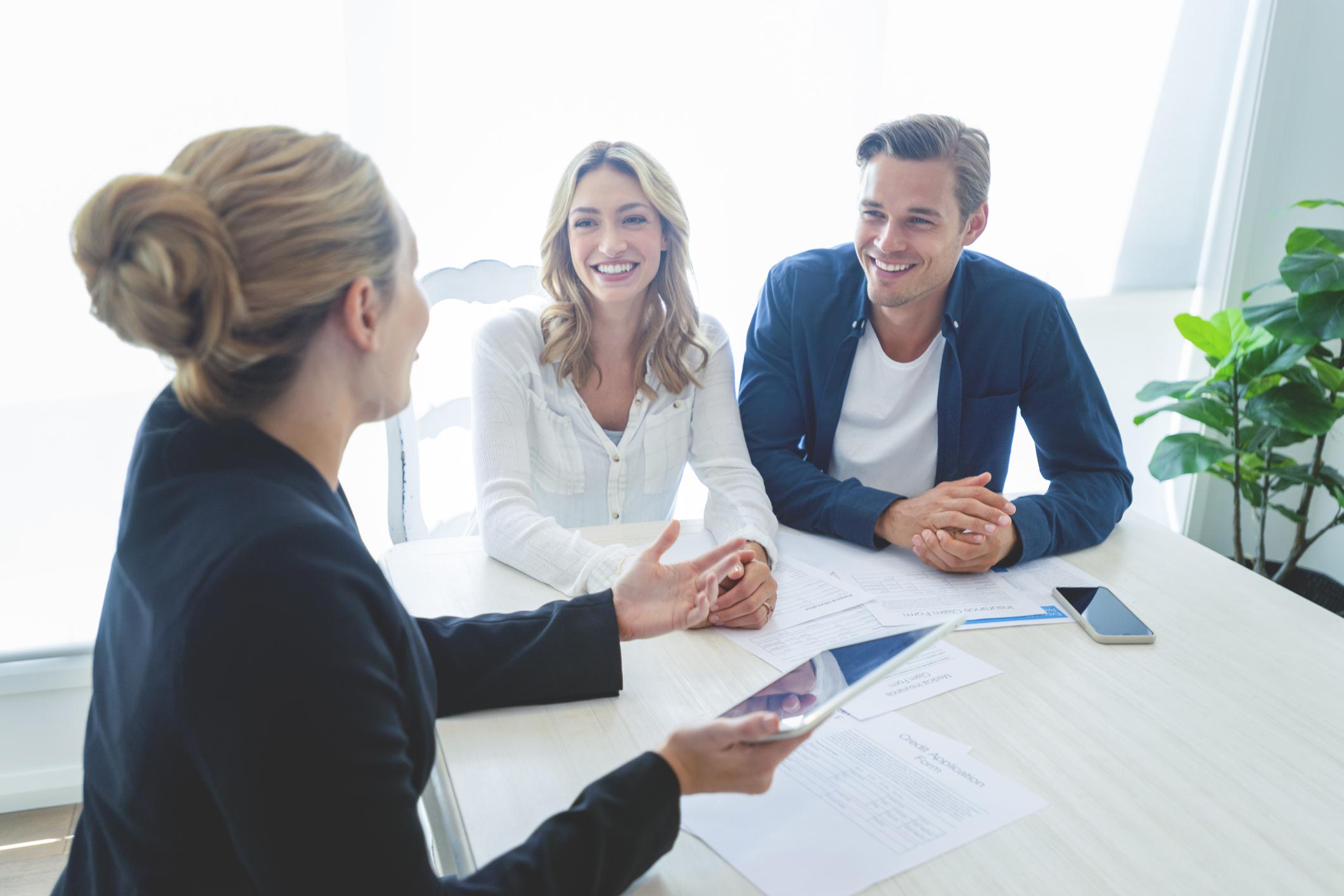 A couple talking to an agent